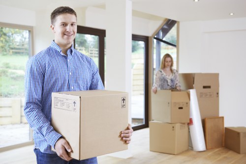 Local removal team handling boxes and household items with care