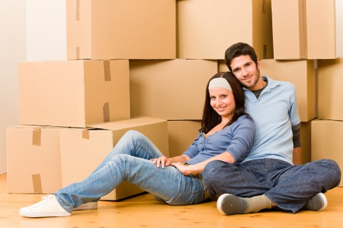 Professional house removalists loading items into a van