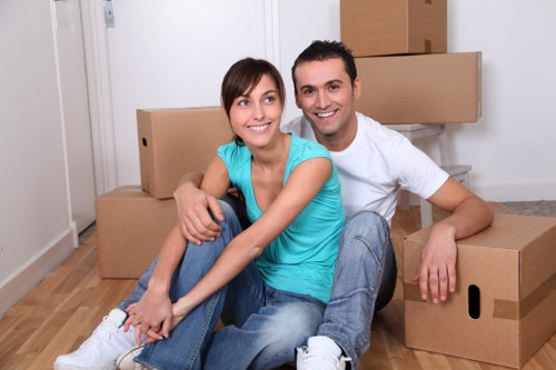 Professional movers carrying furniture from a flat in Wormwood Scrubs