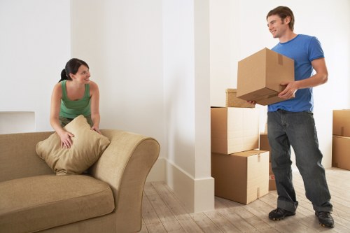 Movers transporting desks and boxes from a local office